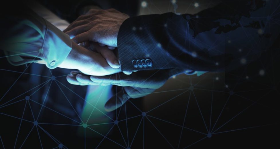 Business people stacking hands in the dark Business people stacking hands in the dark